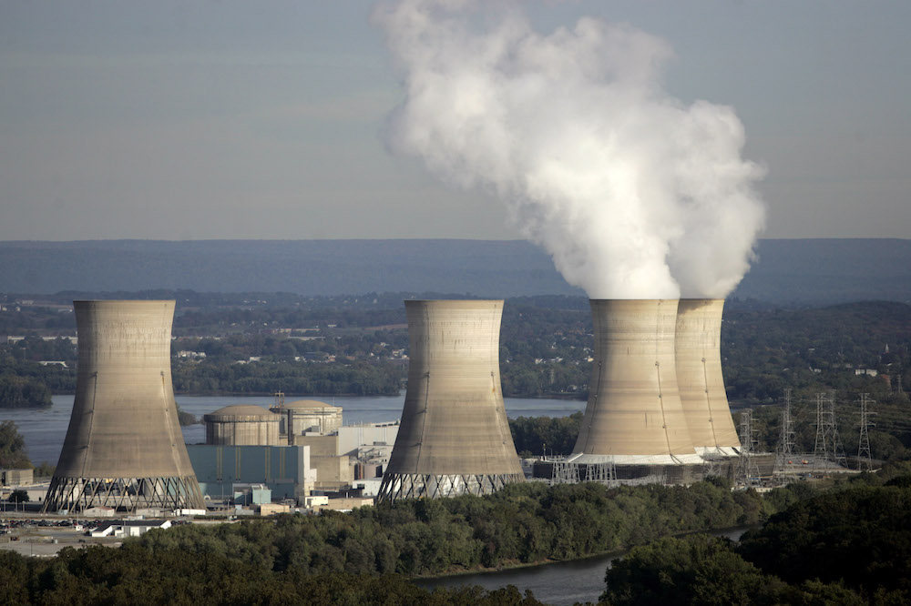 Smoke billows from two active cooling towers of the Three Mile Island nuclear power plant in Middletown, Pa., Wednesday, Oct. 19, 2005. The power plant is nestled on an island in the middle of the Susquehanna River. (AP Photo/Carolyn Kaster)